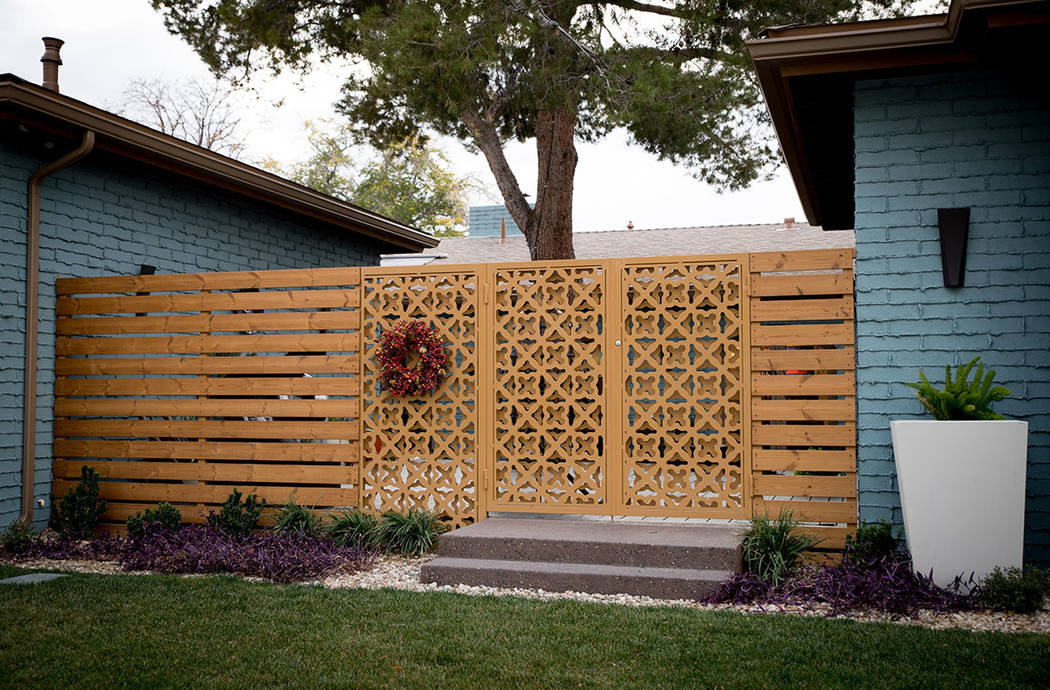 The metal front gate's design was inspired by woodwork from the 1951 home. (Tonya Harvey Real E ...