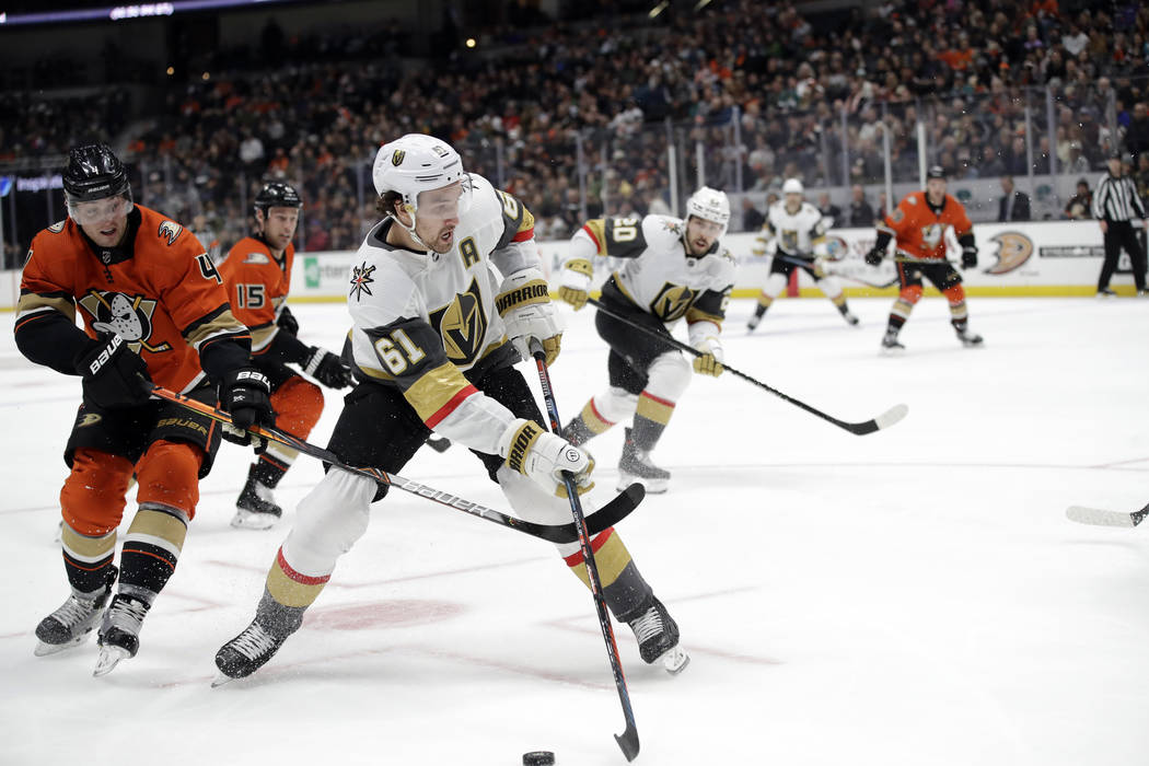 Vegas Golden Knights' Mark Stone (61) is defended by Anaheim Ducks' Cam Fowler, left, during th ...