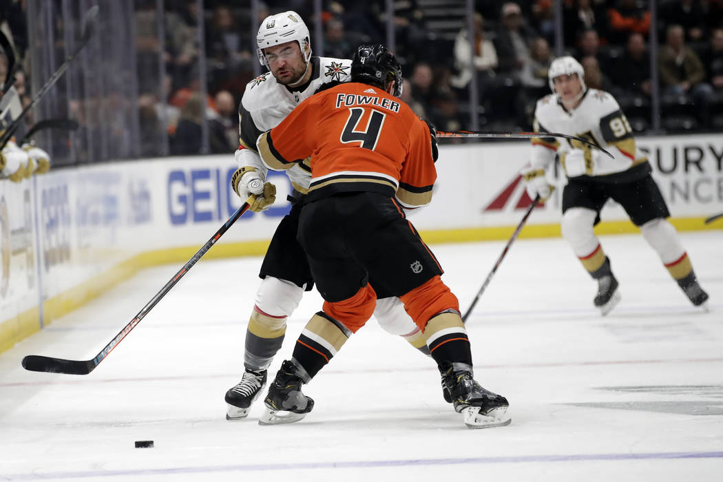 Vegas Golden Knights' Nick Holden, left, collides with Anaheim Ducks' Cam Fowler (4) during the ...