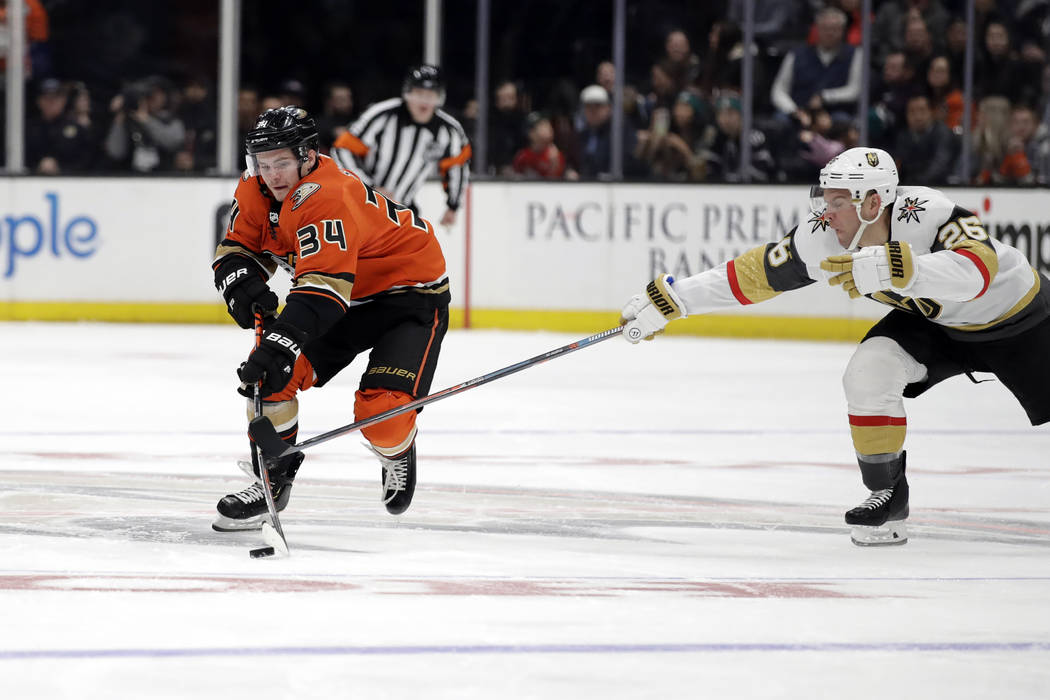 Anaheim Ducks' Sam Steel (34) is defended by Vegas Golden Knights' Paul Stastny (26) during the ...