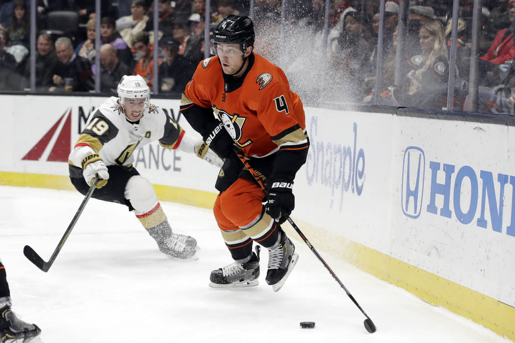 Anaheim Ducks' Cam Fowler (4) controls the puck in front of Vegas Golden Knights' Reilly Smith ...