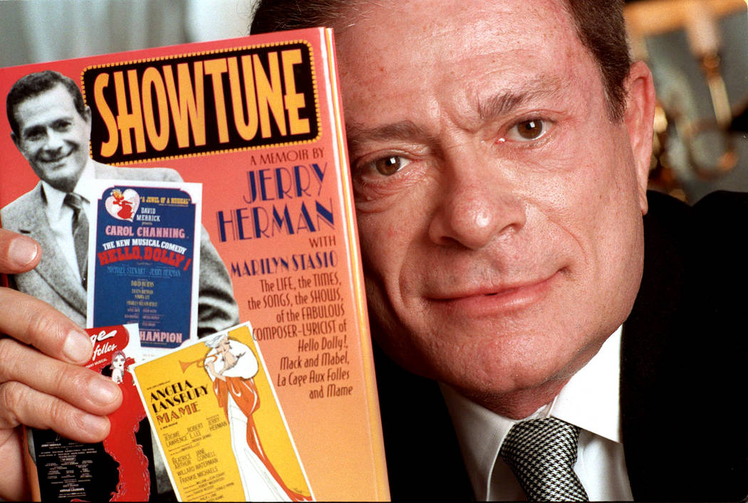 In a Nov. 19, 1996, file photo, composer Jerry Herman displays his book "Showtune," in New York ...