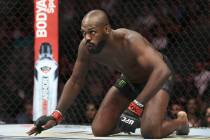 Jon Jones crawls towards the middle of the ring before the start of his light heavyweight title ...