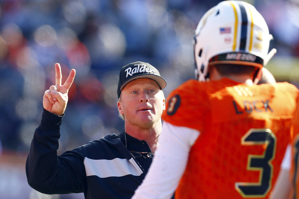 North head coach Jon Gruden, of the Oakland Raiders, talks with North quarterback Drew Lock, of ...