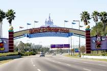 Cars travel one of the roads leading to Walt Disney World in Lake Buena Vista, Fla. (AP Photo/J ...