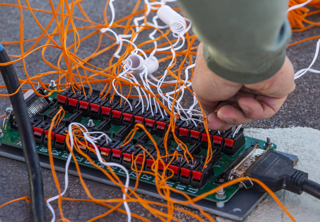 Salvatore Camarda with Fireworks by Grucci checks the wiring on a bank of loaded mortars as the ...