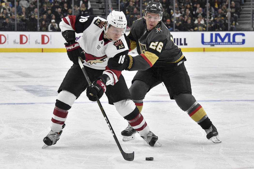 Arizona Coyotes center Christian Dvorak (18) and Vegas Golden Knights center Paul Stastny vie f ...