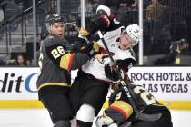 Arizona Coyotes center Christian Dvorak (18) battles between Vegas Golden Knights center Paul S ...