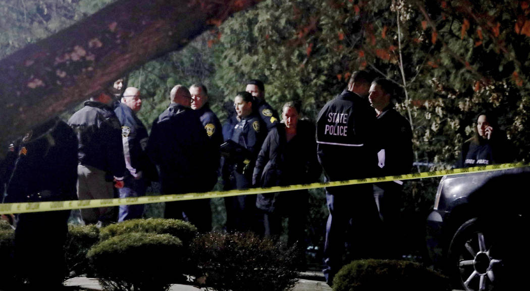 Police gather outside a residence in Monsey, N.Y., early Sunday, Dec. 29, 2019, following a sta ...