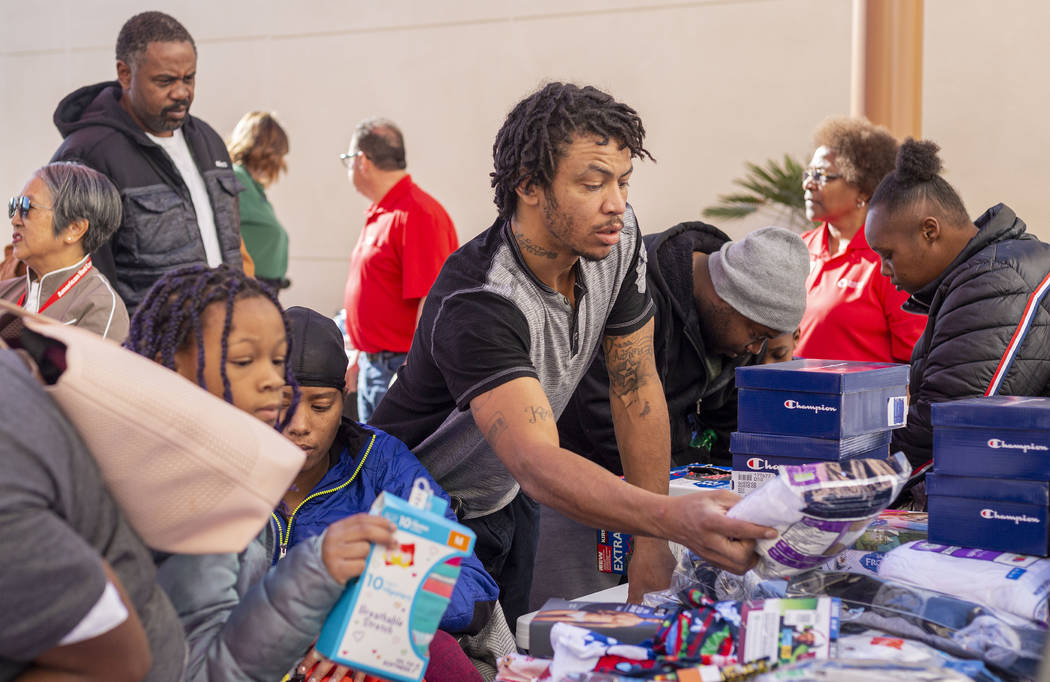 Tenants of the Alpine Motel pick different clothing items and hygiene products at SHARE Village ...