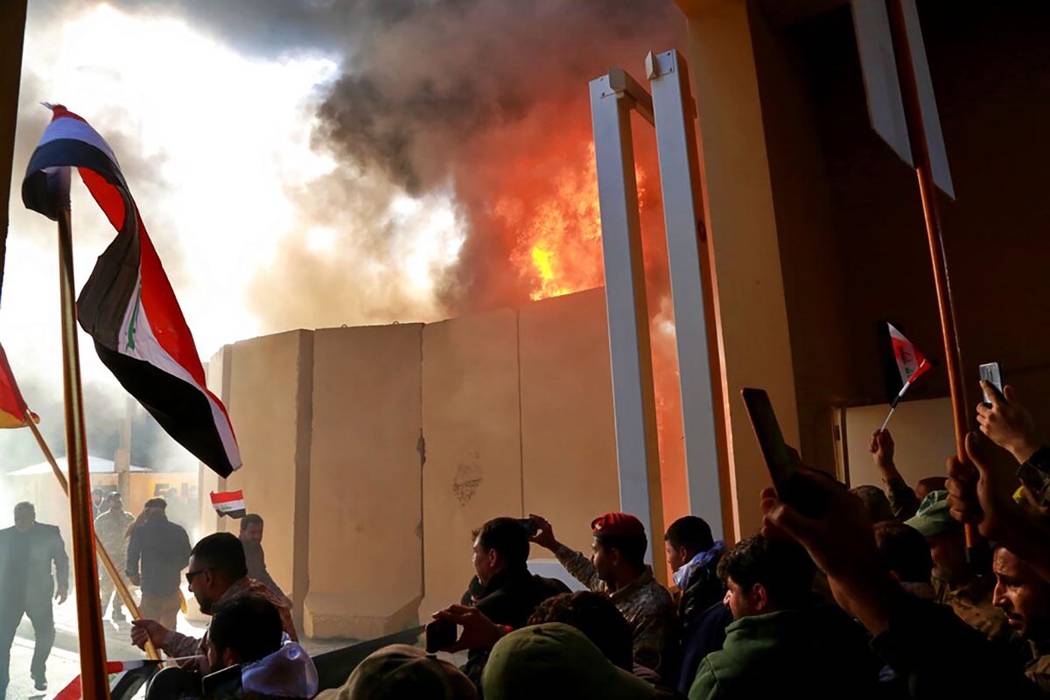 Protesters break into the U.S. embassy compound, in Baghdad, Iraq, Tuesday, Dec. 31, 2019. Doze ...