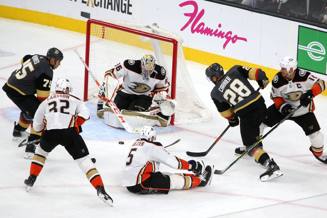 Vegas Golden Knights right wing Ryan Reaves (75) and left wing William Carrier (28) battle for ...