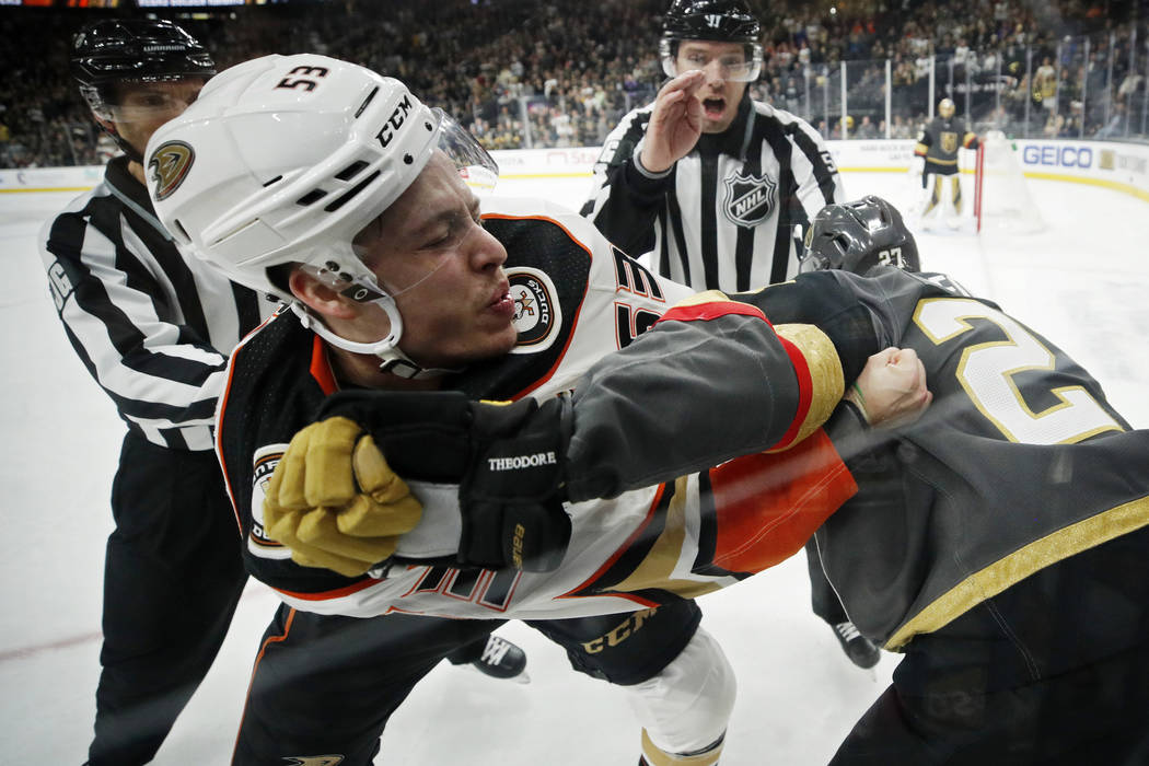 Anaheim Ducks left wing Max Comtois (53) fights with Vegas Golden Knights defenseman Shea Theod ...