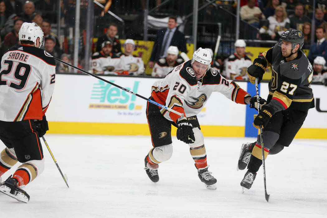 Vegas Golden Knights defenseman Shea Theodore (27) takes a shot at the goal while knocking the ...