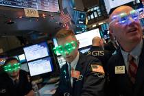 Stock traders wear New Year's 2020 party glasses at the New York Stock Exchange, Tuesday, Dec. ...