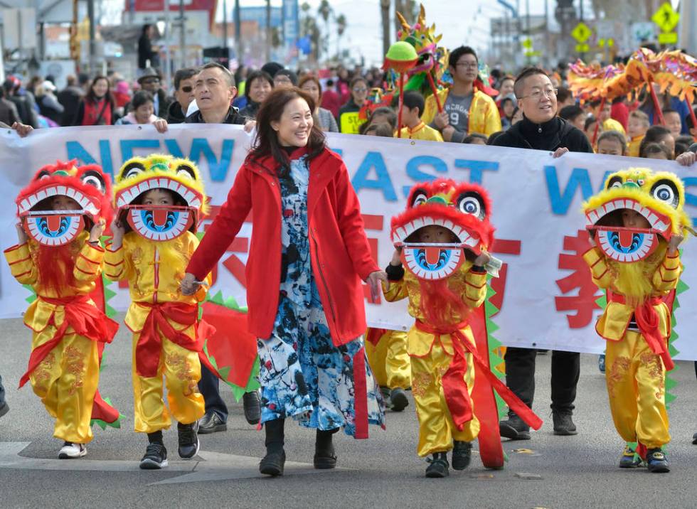 Principal Susan Wang, center, leads a group from the New East West Learning Center during a par ...