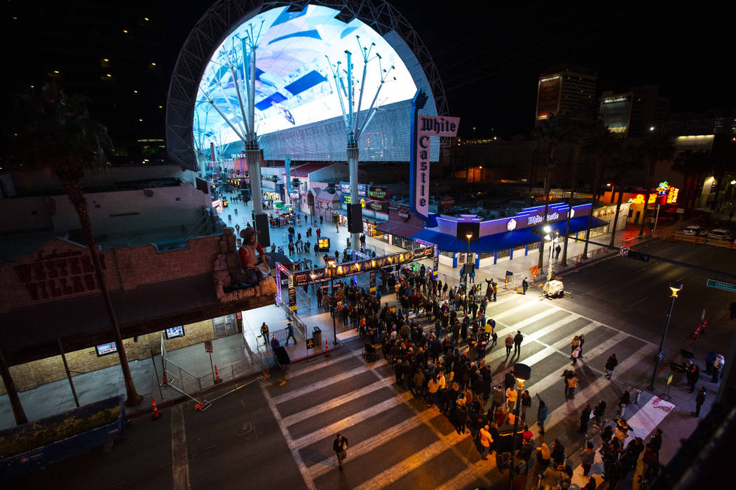 New Year's Eve revelers line up to enter the Fremont Street Experience in downtown Las Vegas on ...
