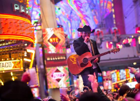 Tony Marques performs as New Year's Eve revelers gather at the Fremont Street Experience in dow ...