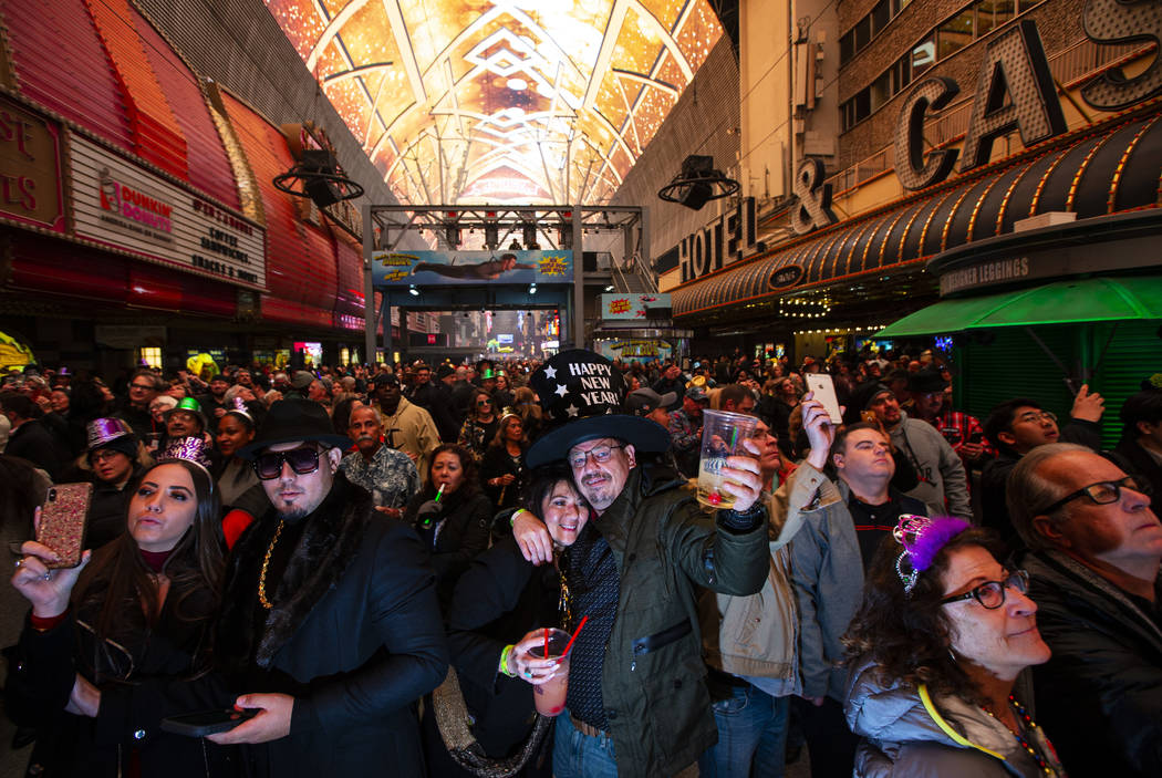 Revelers, including Karrie Wagner and James Green, of Dallas, center, celebrate during a New Ye ...