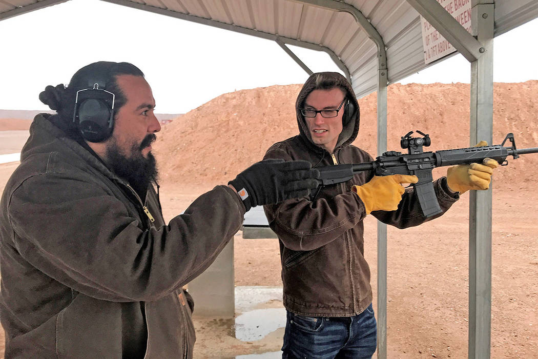 Chad Forsyth instructs Dallin Nielsen how to shoot a modern sporting rifle with the aid of a re ...