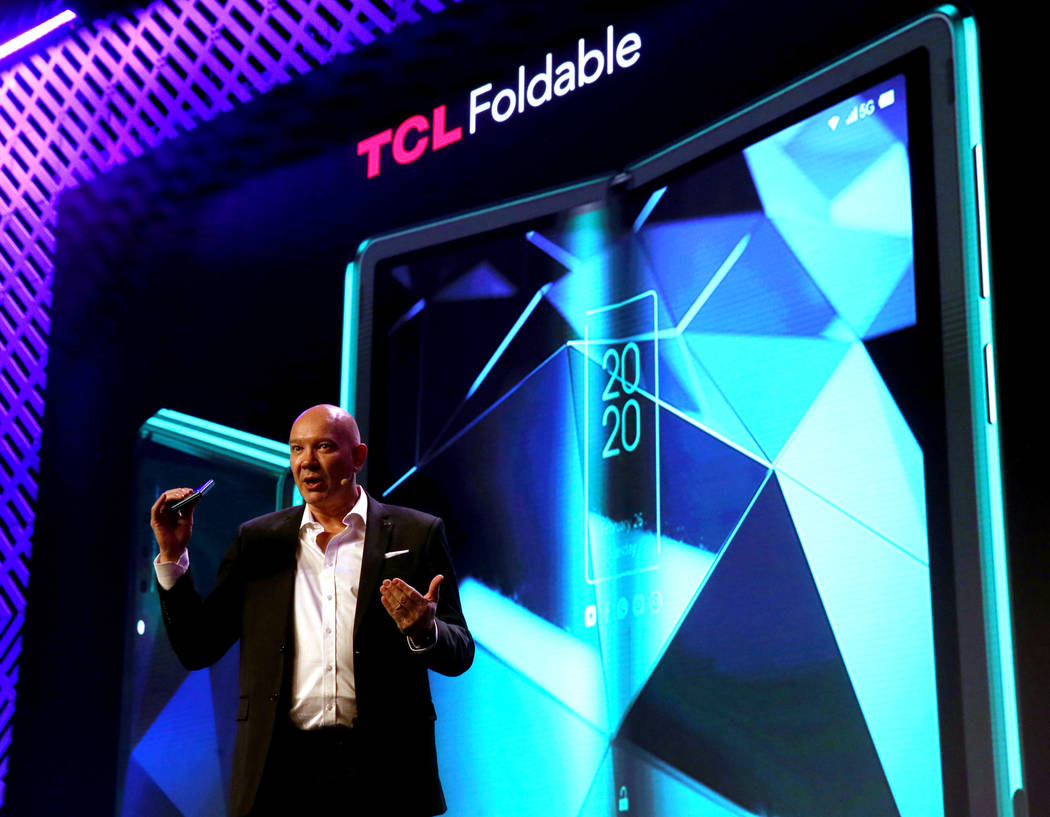 Stefan Streit, general manager of global marketing for TCL Mobile, shows shows a foldable scree ...