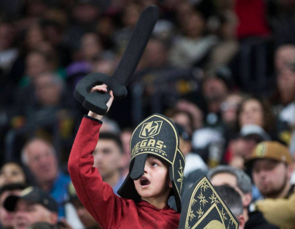 Golden Knights fans cheer for Vegas in the second period of an NHL hockey game against the Phil ...
