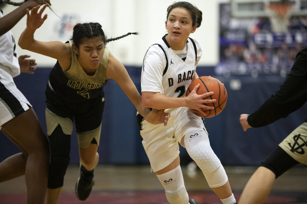 Spring Valley guard Chelsea Camara, left, defends against Desert Oasis guard Isabella Jaramillo ...