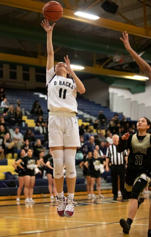 Desert Oasis's forward Olivia Bigger (11) shoots a point during the game against Spring Valley ...