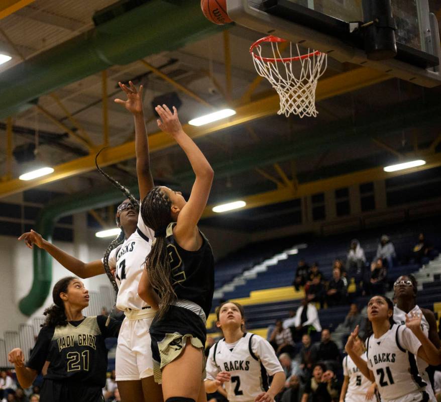 Desert Oasis's center Jordyn Stroud (12) jumps to block a shot by Spring Valley's guard Garrise ...