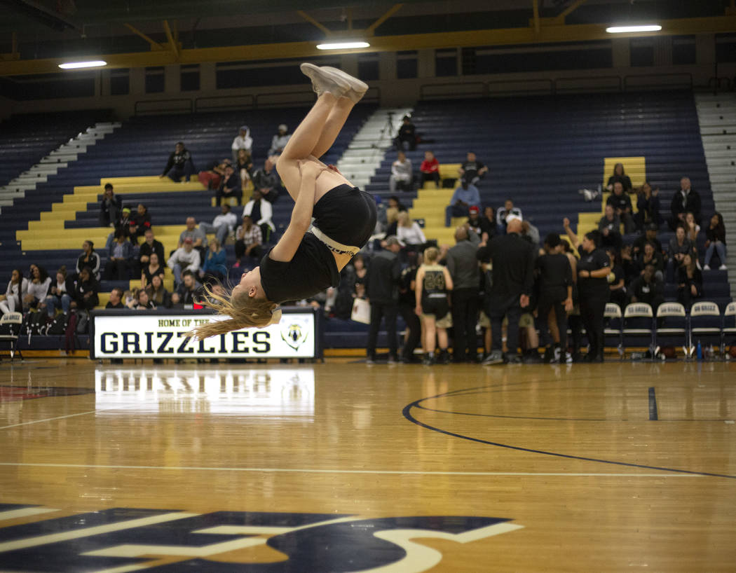 The Spring Valley High School cheerleading squad does flips during a timeout during the basketb ...