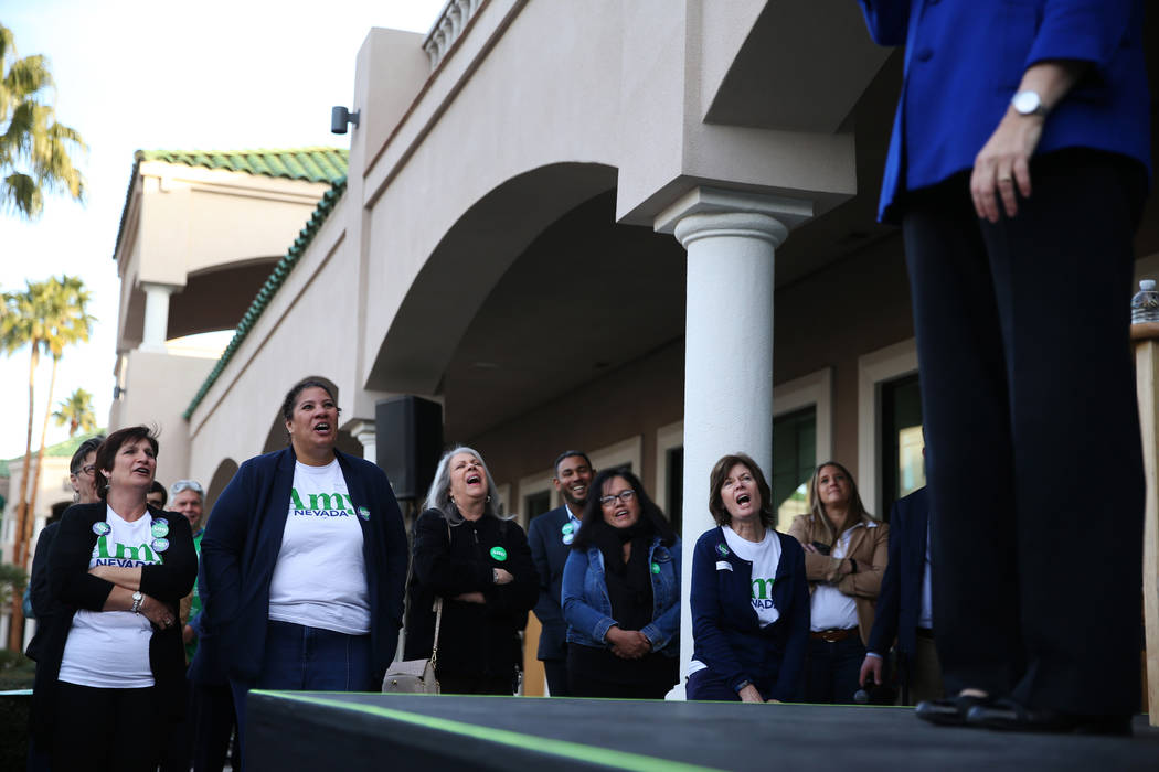 Supporters listen to Democratic presidential candidate Amy Klobuchar speak during a campaign ra ...