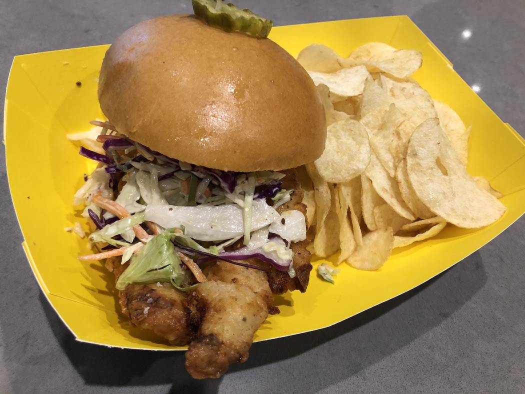 Biloxi fried chicken sandwich from Honey Salt is topped with slaw and Durkee dressing on a brio ...