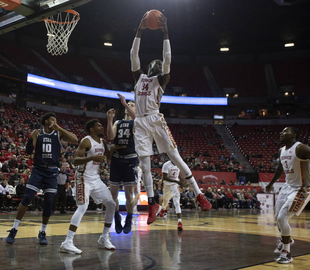 UNLV's forward Mbacke Diong (34) blocks a Utah State point during the second half of the game o ...