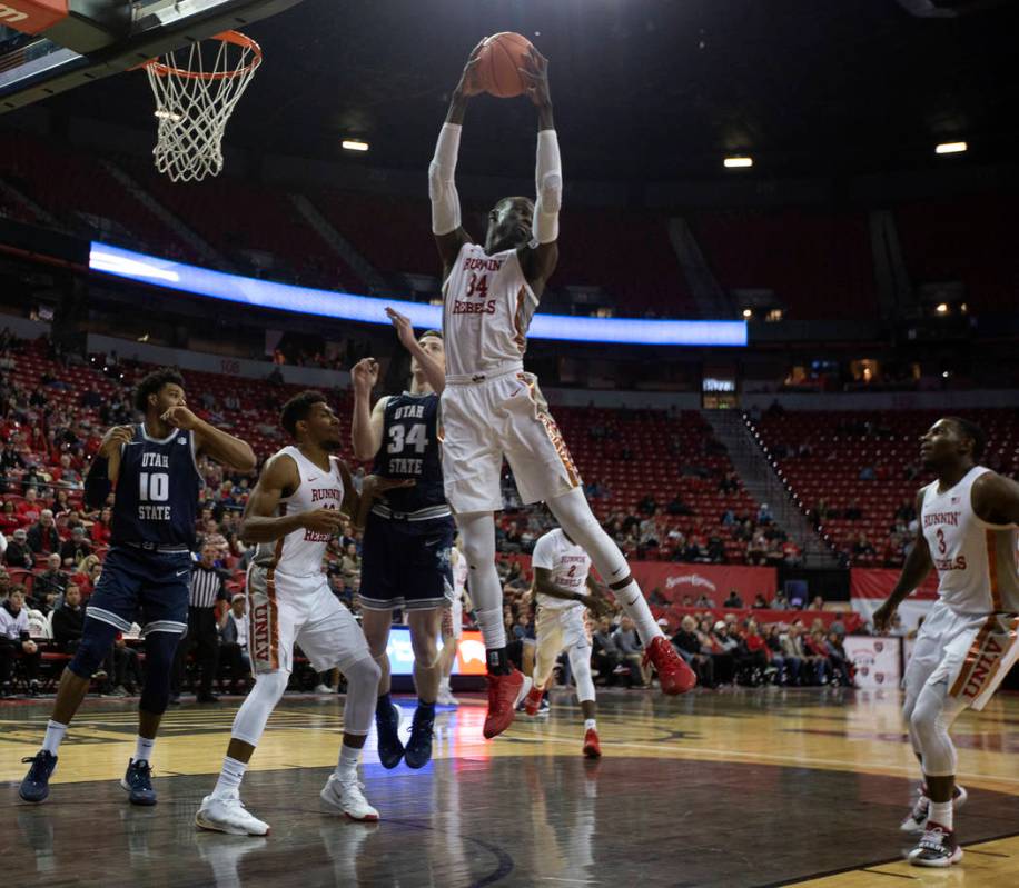 UNLV's forward Mbacke Diong (34) blocks a Utah State point during the second half of the game o ...