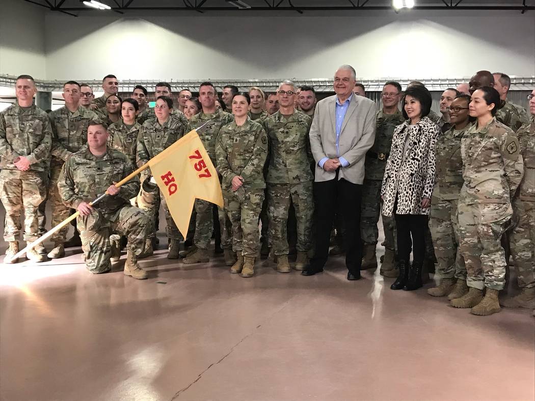 Gov. Steve Sisolak and first lady Kathy Sisolak pose with departing soldiers from the Nevada Ar ...