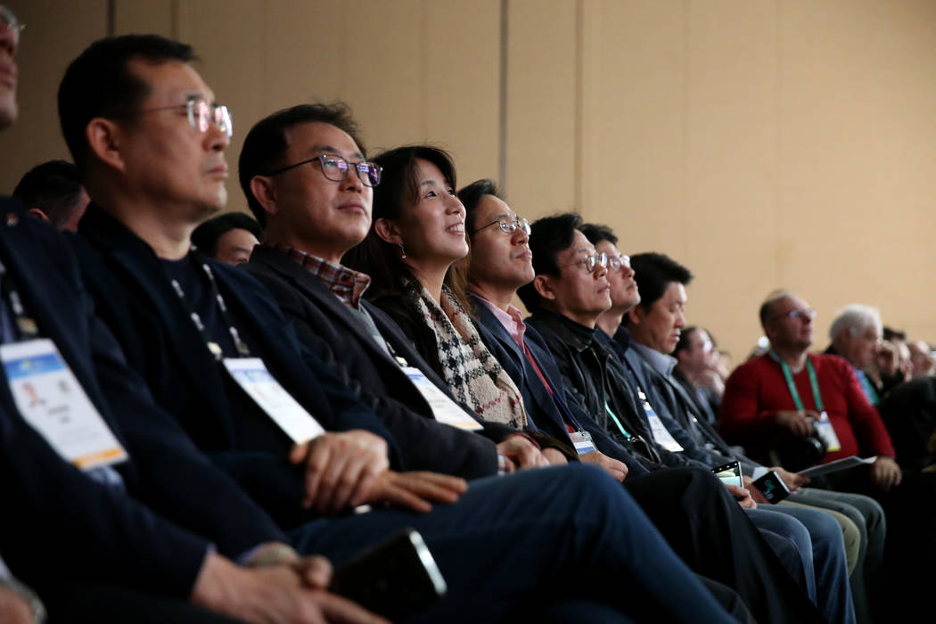 Members of the news media watch the LG Electronics news conference at Mandalay Bay Convention C ...
