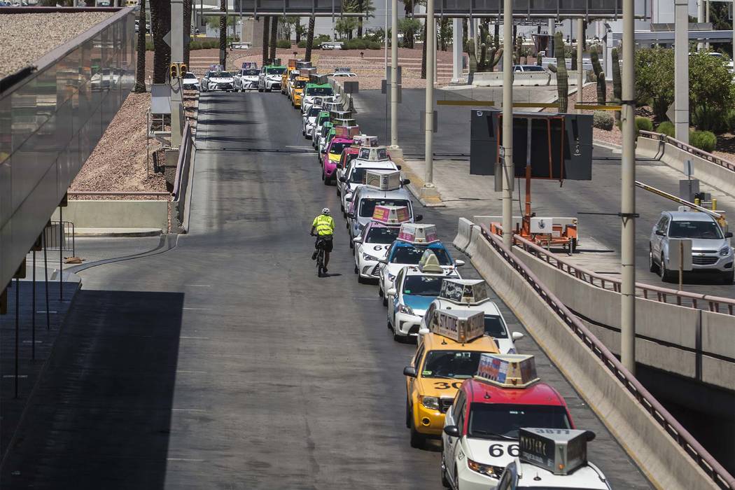 Taxis wait outside Terminal 1 at McCarran International Airport on Thursday, June 28, 2018, in ...
