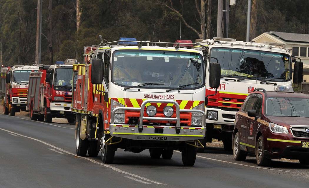 Firetrucks at staging area at Nowra, Australia, prepare to disperse to fires, Saturday, Jan. 4, ...