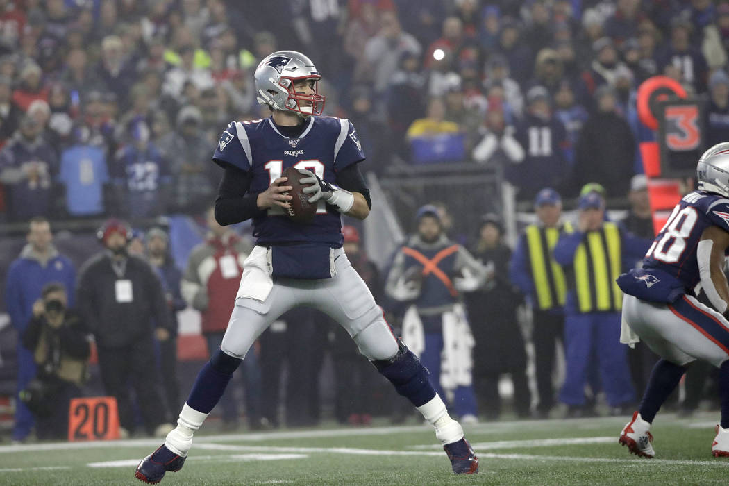 New England Patriots quarterback Tom Brady drops back to pass against the Tennessee Titans in t ...