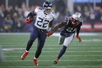 Tennessee Titans running back Derrick Henry runs from New England Patriots safety Duron Harmon, ...