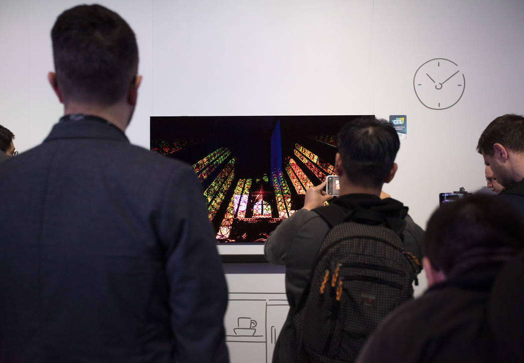 People photograph Samsung's "The Frame" TV at Samsung's CES 2020 First Look event on Sunday, Ja ...