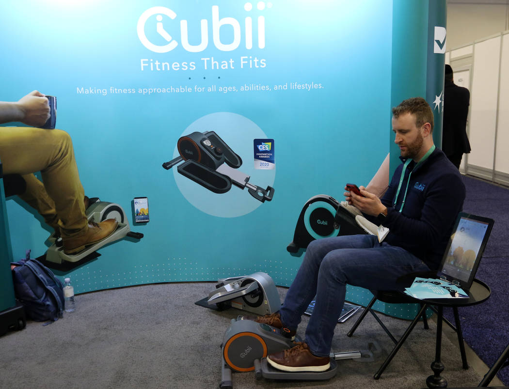 Jon Osting of Cubii displays how their compact elliptical works at the CES trade show at the Sa ...