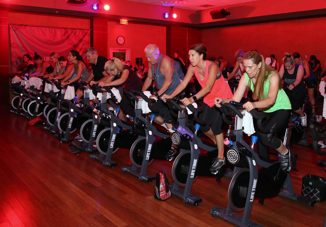 Members at Life Time Athletic club exercise during spinning class on Monday, June 3, 2019, in H ...