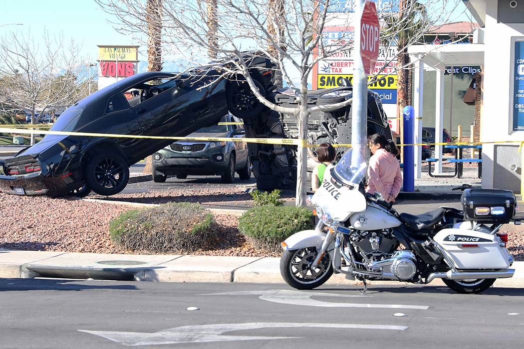 Employees of a Dutch Bros coffee shop at 590 E. Windmill Lane look at a car crash in their driv ...