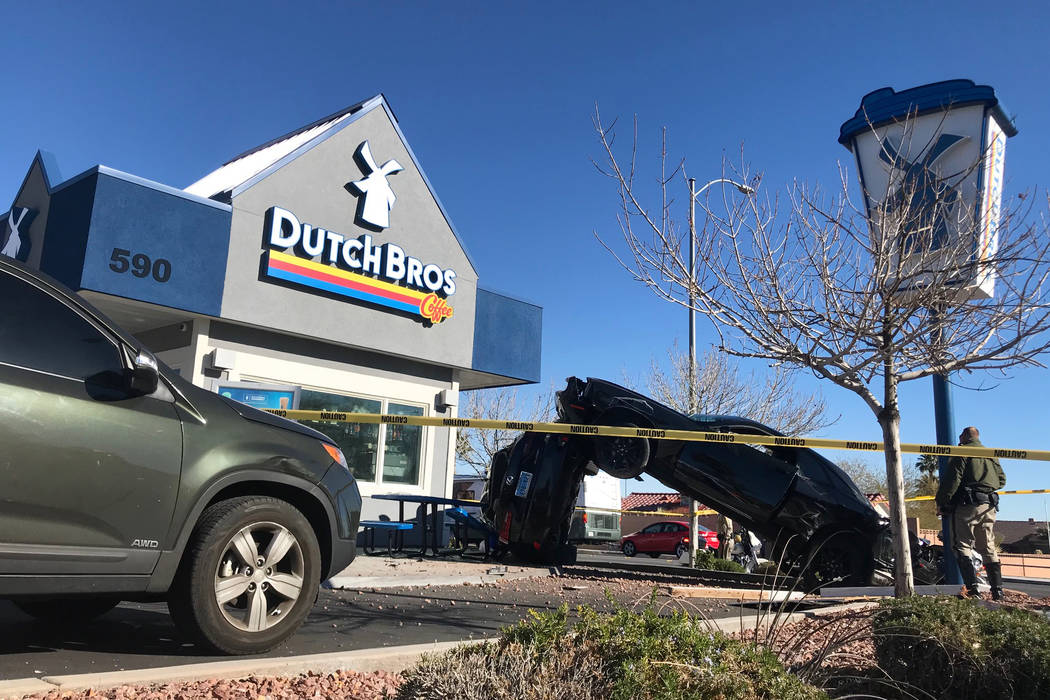 A crash outside a Dutch Bros coffee shop at 590 E. Windmill Lane left one vehicle on its side a ...