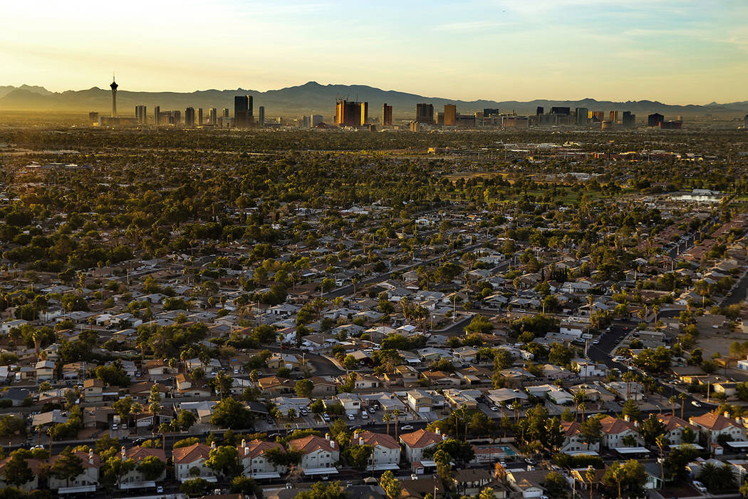 The sun rises on the city looking to the Strip from the west end on Wednesday, Oct. 16, 2019, i ...