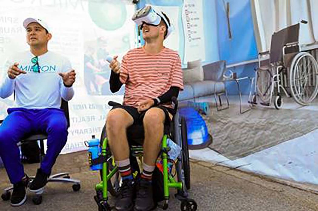 Mieron VR's Josh Dubon assists a patient using virtual reality technology during therapy. (Mier ...