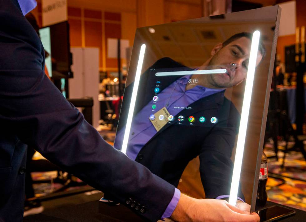 Jonathan Caparco demonstrates a Capstone smart mirror the during Pepcom's Digital Experience! C ...