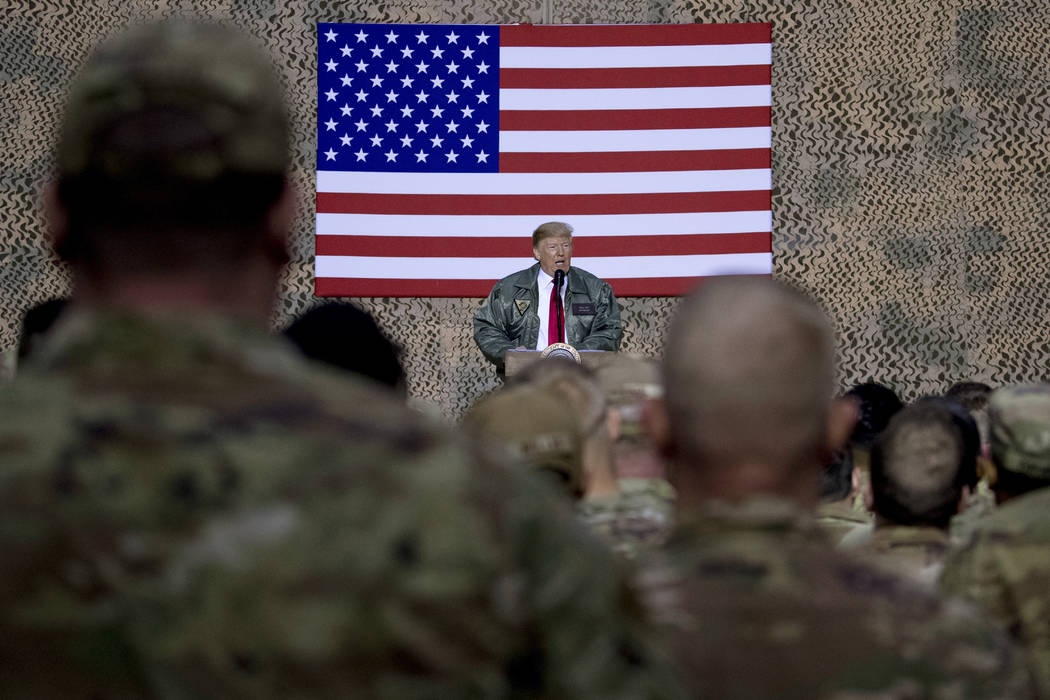 FILE - In this Dec. 26, 2018, file photo, President Donald Trump speaks to members of the milit ...