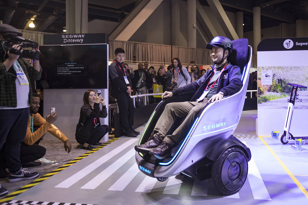 Segway Vice President Chen Huang demonstrates the S-Pod transporter at CES at the Las Vegas Con ...